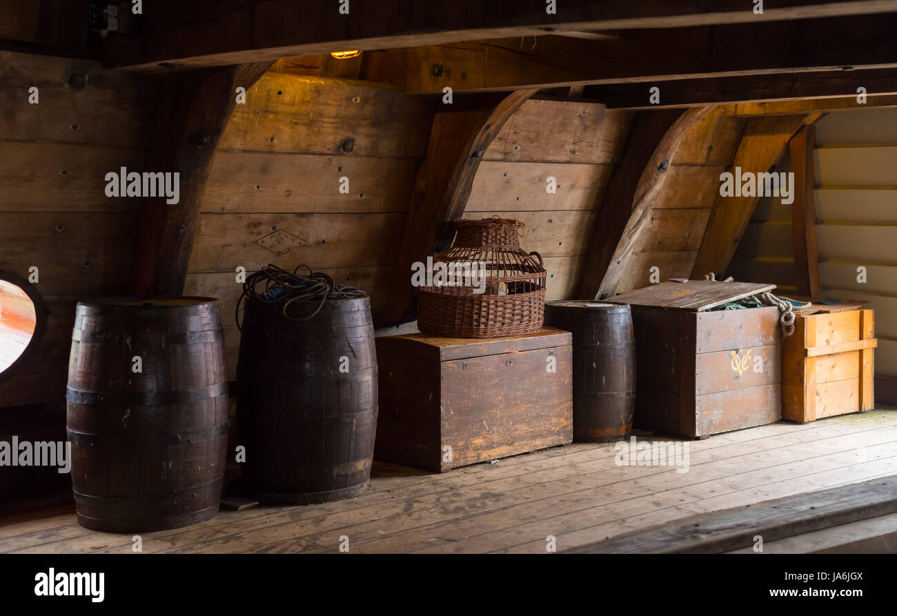 wooden crates and barrels on board of a restored dutch VOC ship Stock Photo