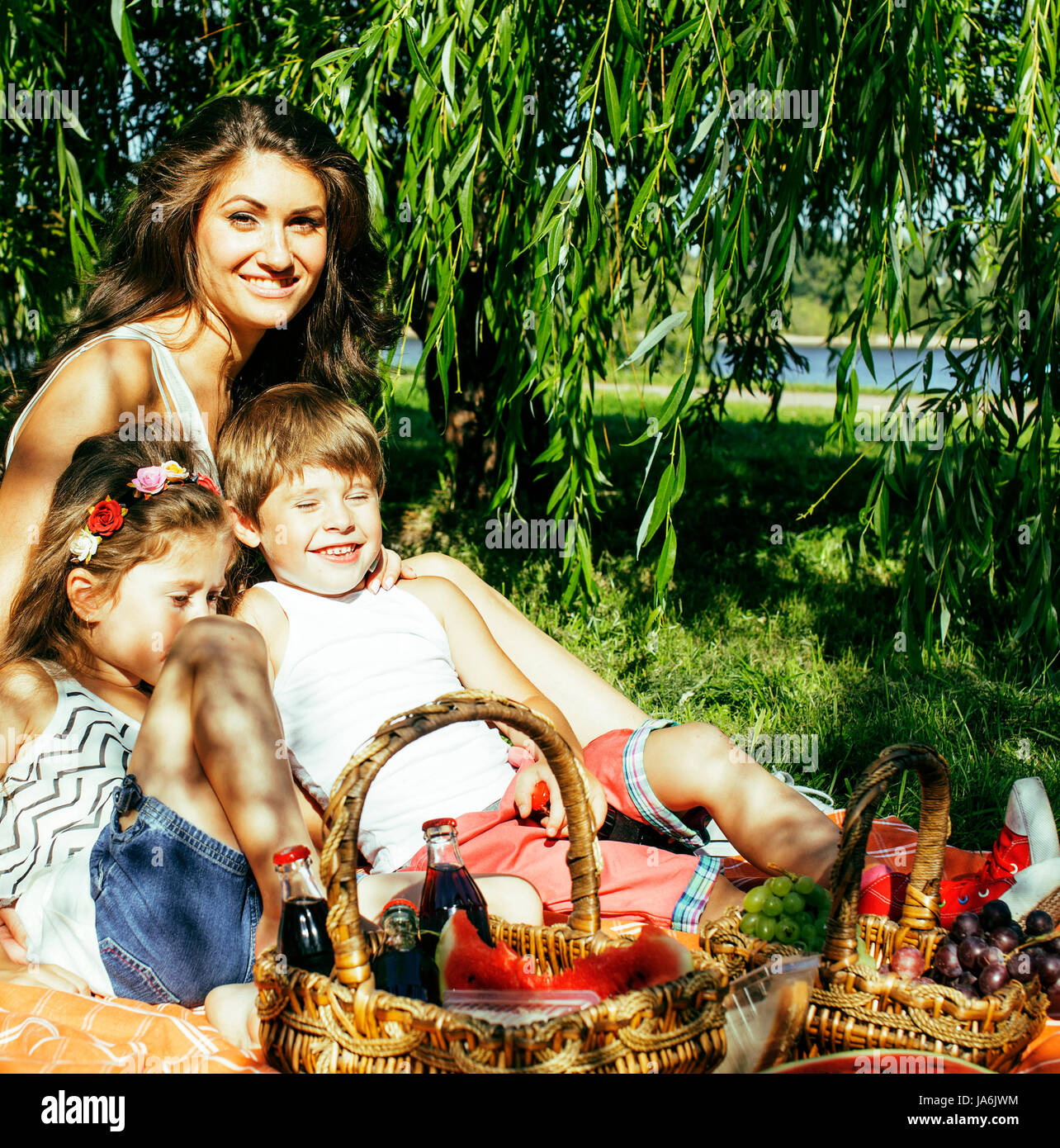 cute happy family on picnic laying on green grass mother and kid Stock ...