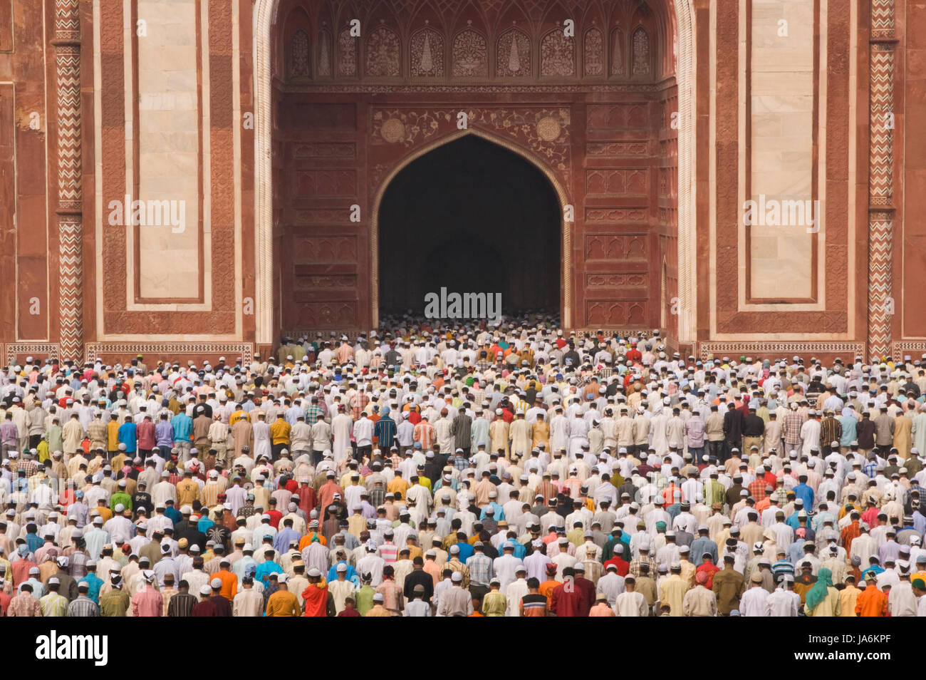 Thousands of gather in front of the mosque at the Taj Mahal to celebrate the Muslim festival of Eid ul-Fitr in Agra, Uttar Pradesh, India. Stock Photo