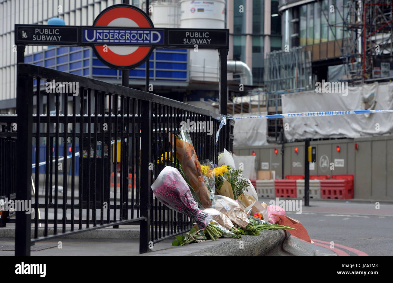 London, UK. 4th June, 2017. Flowers are placed to pay respect to the victims of Saturday's terror attack at the north entrance of London Bridge underground Station in London, Britain on June 4, 2017. British police said 12 people have been arrested so far after the attack, which left seven people dead and 48 injured. Credit: Xinhua/Alamy Live News Stock Photo
