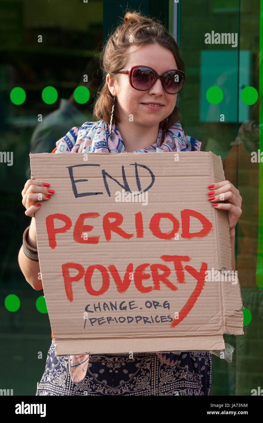 London, UK. 24th August, 2017. A campaigner outside an Asda supermarket in  Stepney Green calls on the supermarket to reduce its prices for tampons to  bring it into line with other supermarkets