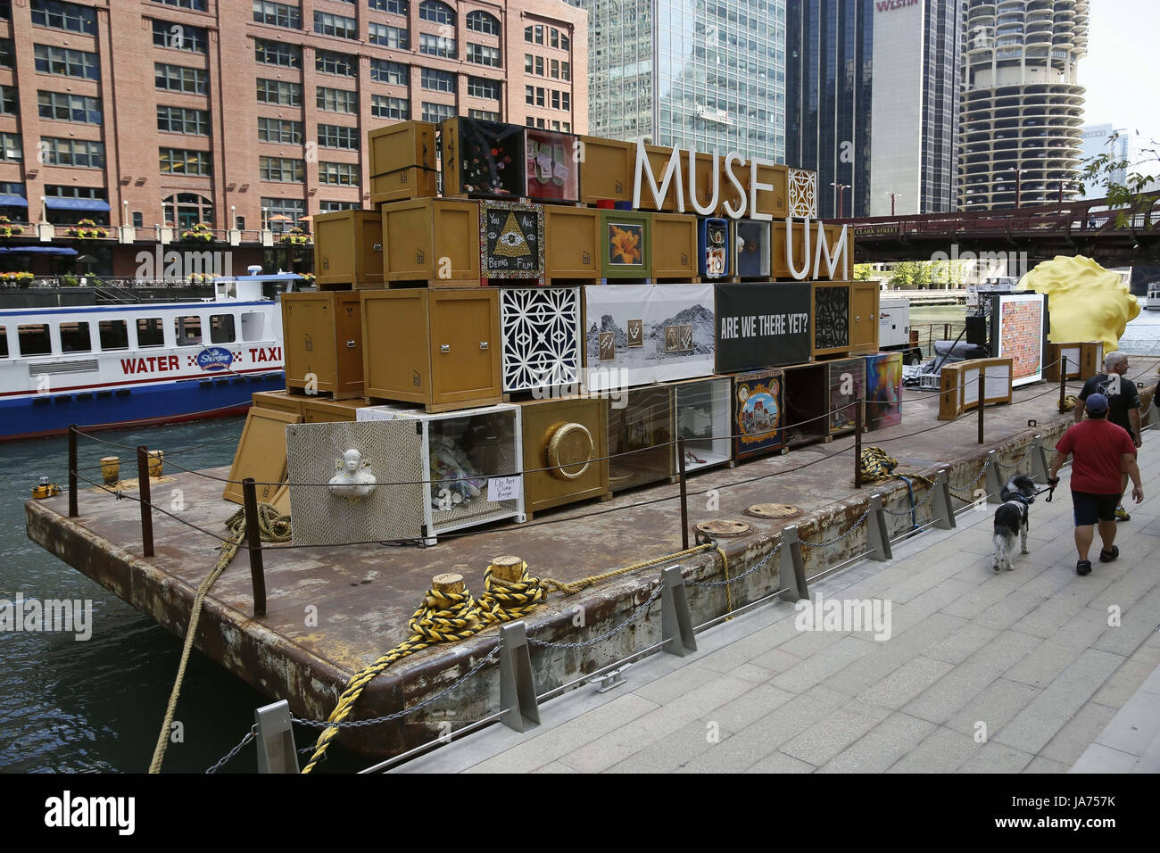 (170824) -- CHICAGO, Aug. 24, 2017 (Xinhua) -- Photo taken on Aug. 23, 2017 shows Floating Museum docked at the riverside in Chicago, the United States. Celebrating the River's industrial past, Floating Museum transforms a barge into an aesthetically striking mobile gallery filled with art crates displaying work created by local artists and our collaborators. Floating Museum exists in the continuum of artists examining their relationship to institutions, and responds to the evolution of museums; ranging from the cabinet of curiosities or Wunderkabinett between the sixteenth and eighteenth cent Stock Photo