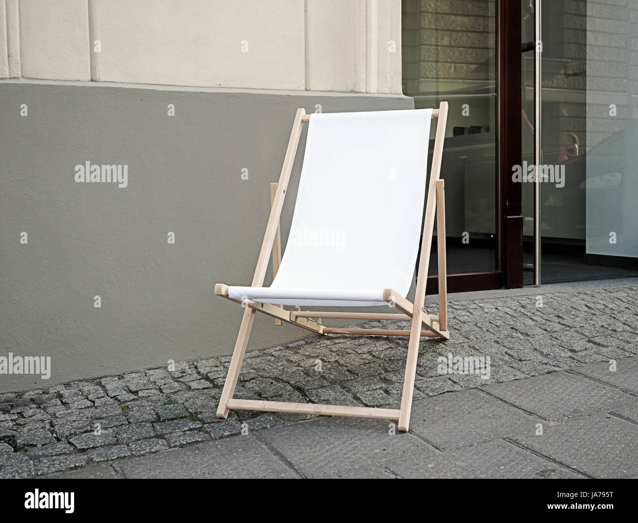 Sunbed, deck chair in a front of a shop on a pedestrian path in the old town Stock Photo