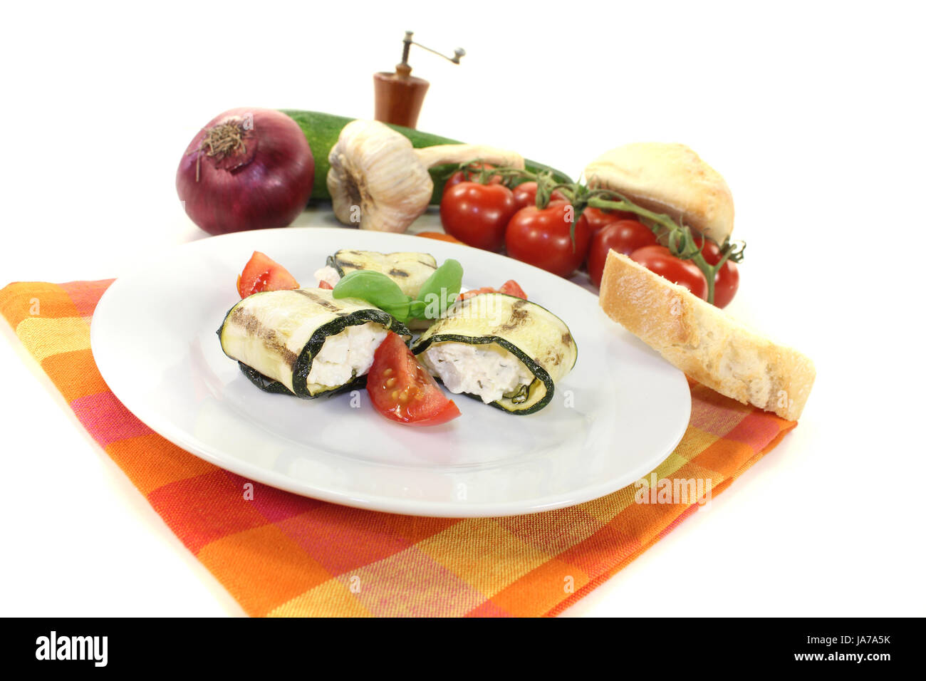 stuffed zucchini rolls with cream cheese on a light background Stock Photo