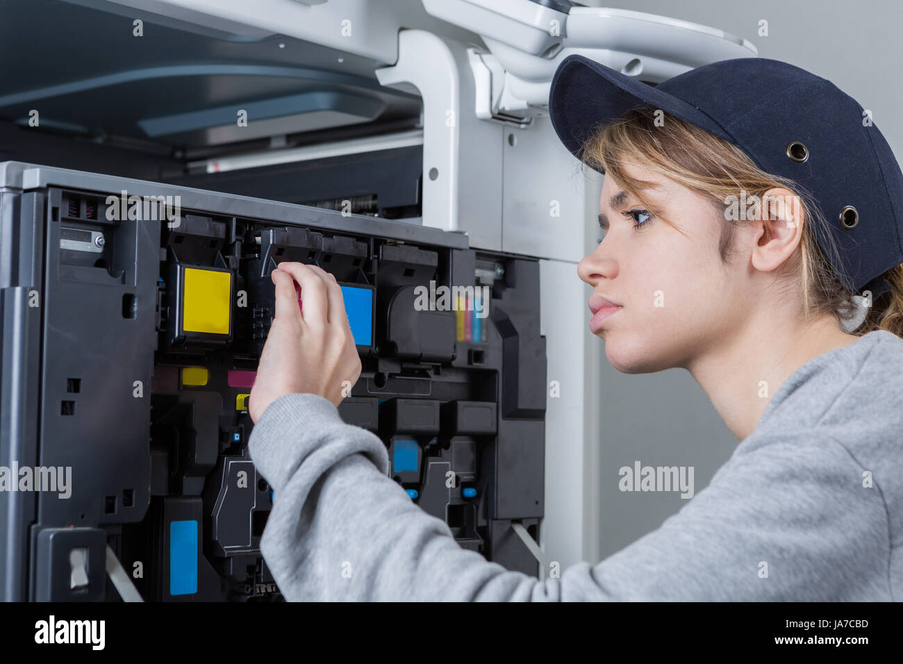young female technician fix the printer Stock Photo - Alamy