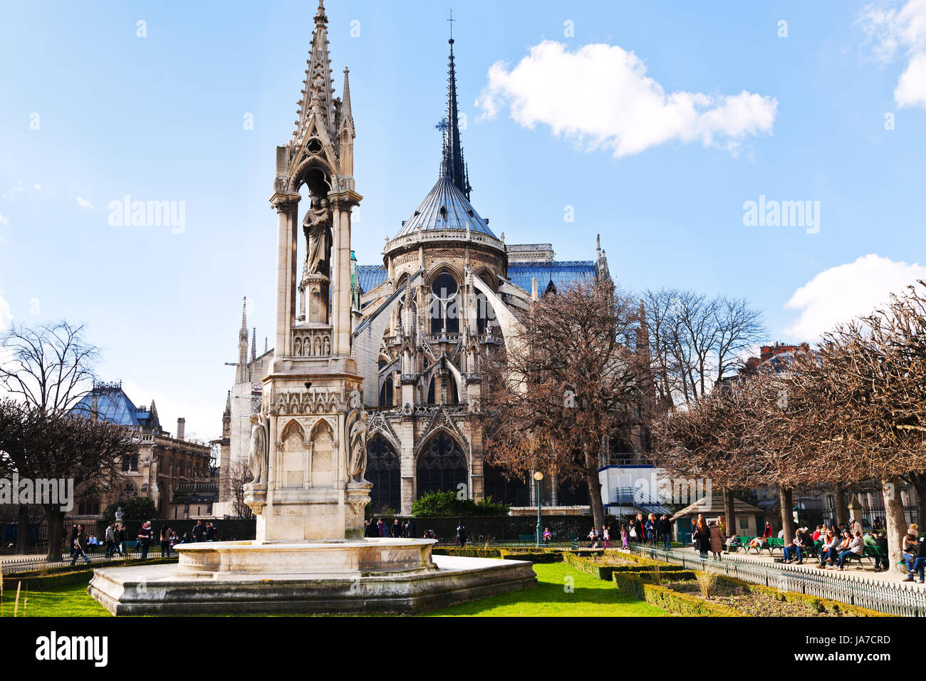 PARIS, FRANCE - MARCH 9: Notre-Dame de Paris and Fountain of the Archdiocese from Square Jean XXIII in Paris on March 9, 2013. Fontaine de l Archeveche was made in 1843-1845 by Alphonse Vigoureux Stock Photo