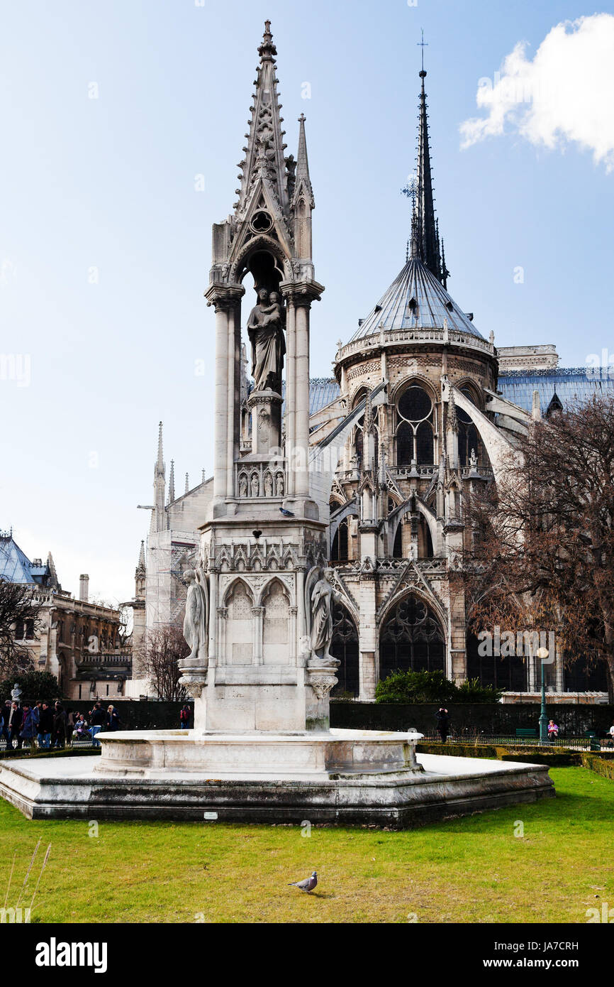 PARIS, FRANCE - MARCH 9: Notre-Dame de Paris and Fountain of the Archdiocese from Square Jean XXIII in Paris on March 9, 2013. Fontaine de l Archeveche was made in 1843–1845 by Alphonse Vigoureux. Stock Photo