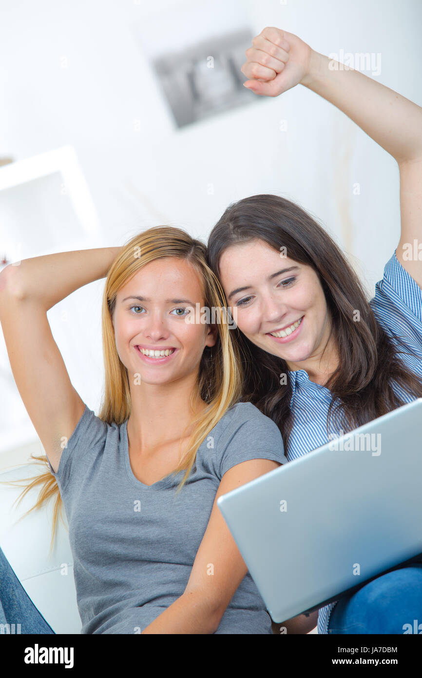 young women using laptop on sofa Stock Photo - Alamy