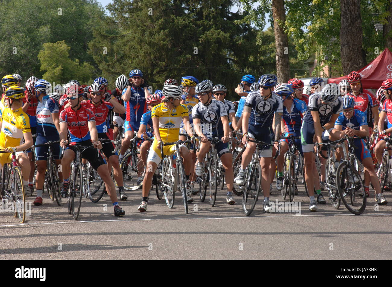 Spring City, Utah, USA - 2 August 2006: Group of cyclists waiting for the the Sanpete Classic Road Race in Sanpete County Utah to begin. Men standing  Stock Photo