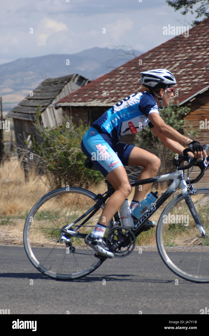 Spring City, Utah, USA - 2 August 2006: Woman  rides a Giant bicycle and Contender Bicycles jersey in the Women's  Sanpete Classic Road Race on a sunn Stock Photo