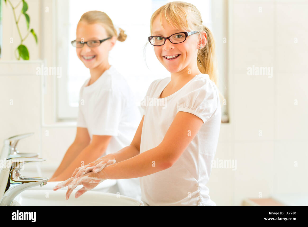 girls when washing hands in the bathroom Stock Photo - Alamy