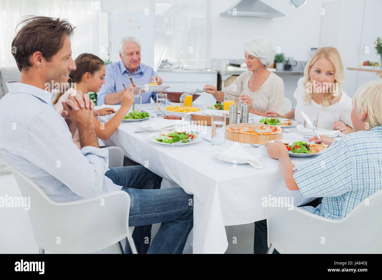 Extended family at the dinner table in kitchen Stock Photo - Alamy