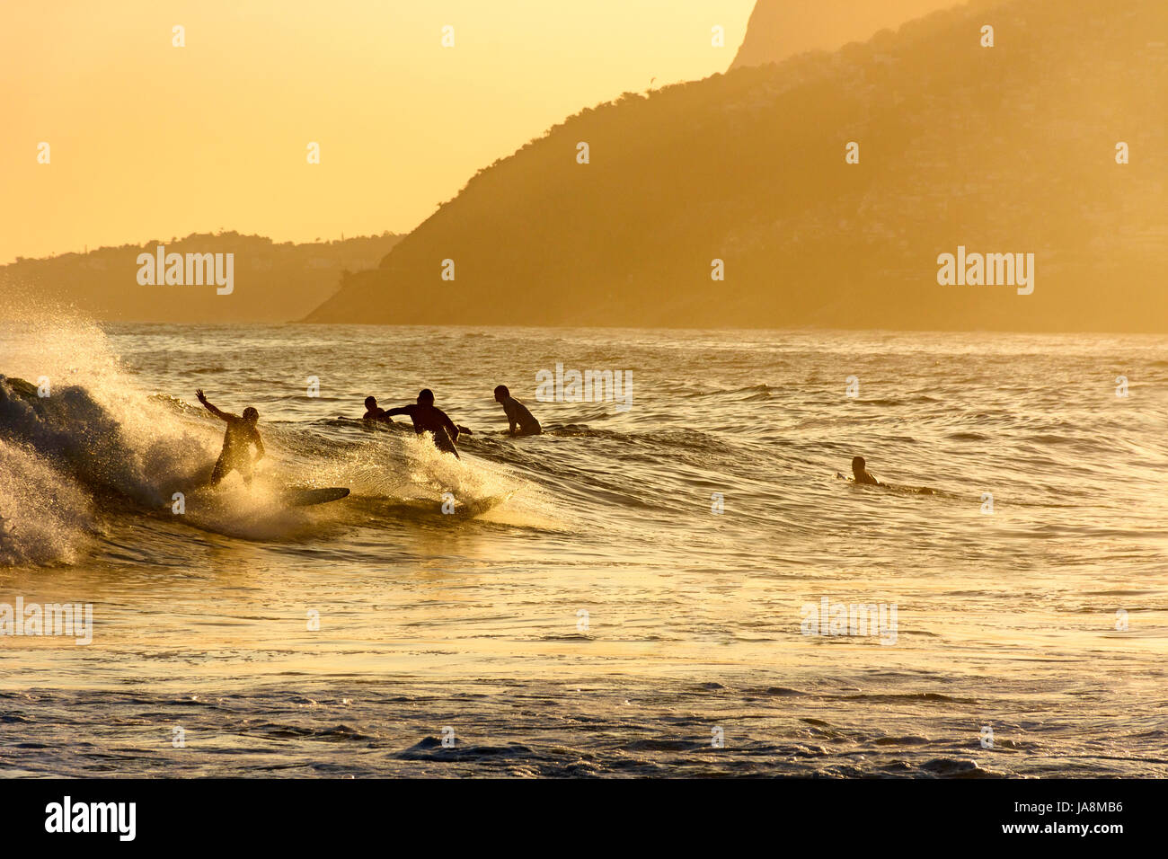 Surfing Rio Surfing during the summer sunset at Ipanema beach in Rio de Janeiro ...