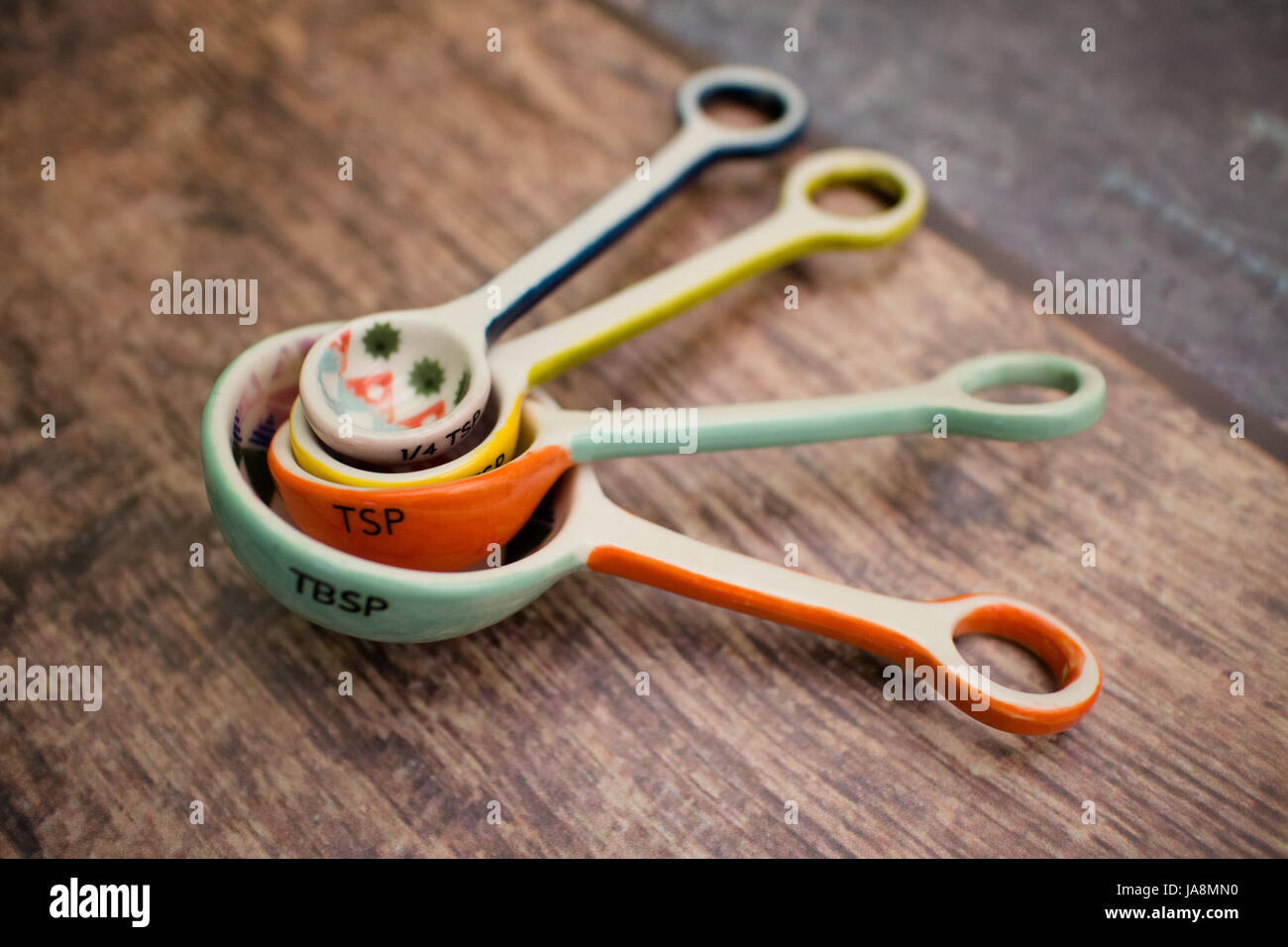 Colorful ceramic measuring spoons for cooking Stock Photo