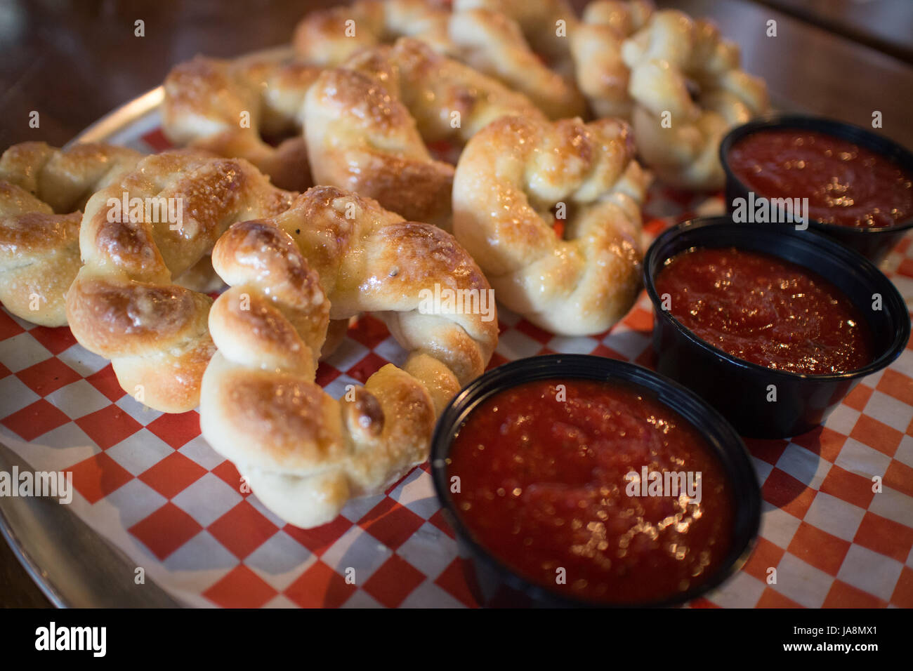 Garlic knots with marinara sauce at an Italian pizzeria Stock Photo Alamy