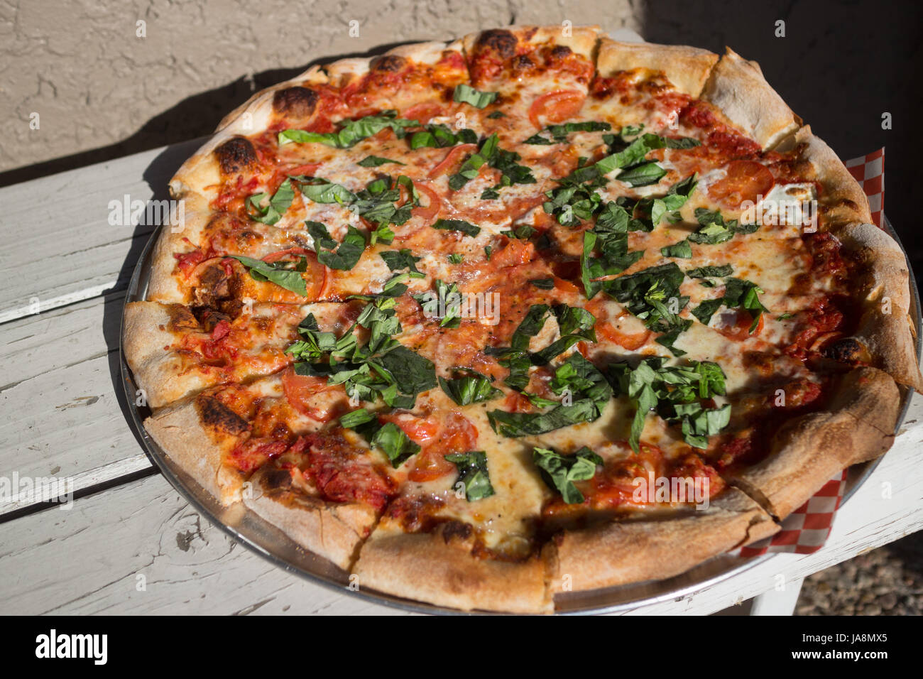 Margarita pizza pie on a white bench Stock Photo