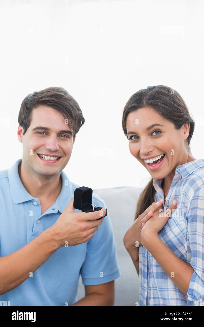 Portrait of a man offering an engagement ring to his surprised partner
