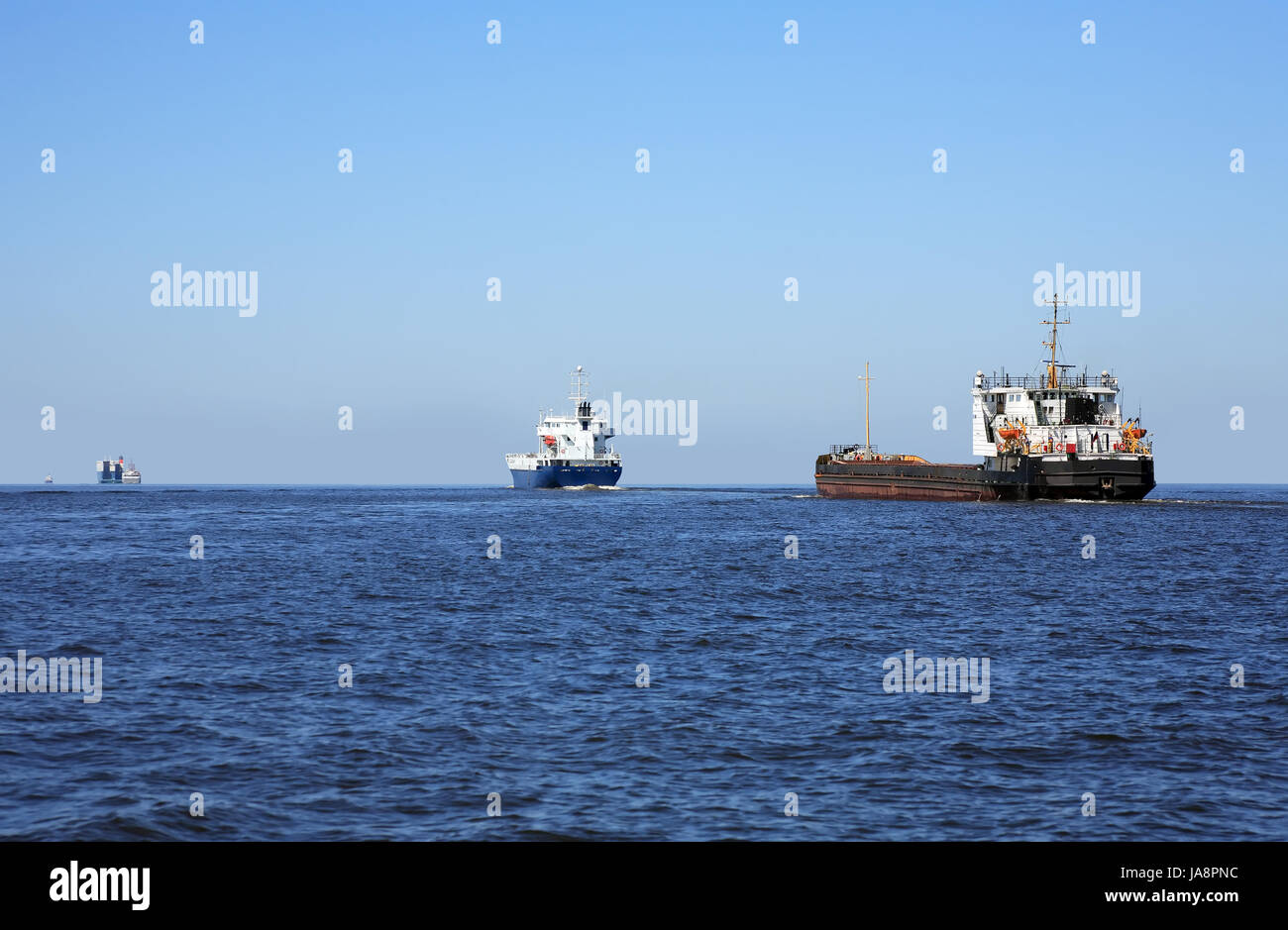 Few nautical vessels in a row on blue sea and sky background Stock Photo