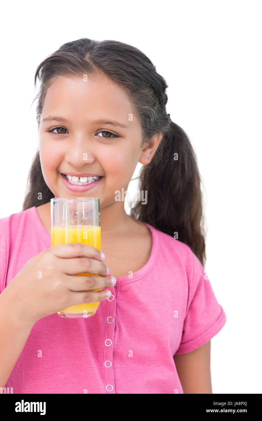 Happy little girl drinking orange juice on white background Stock Photo ...