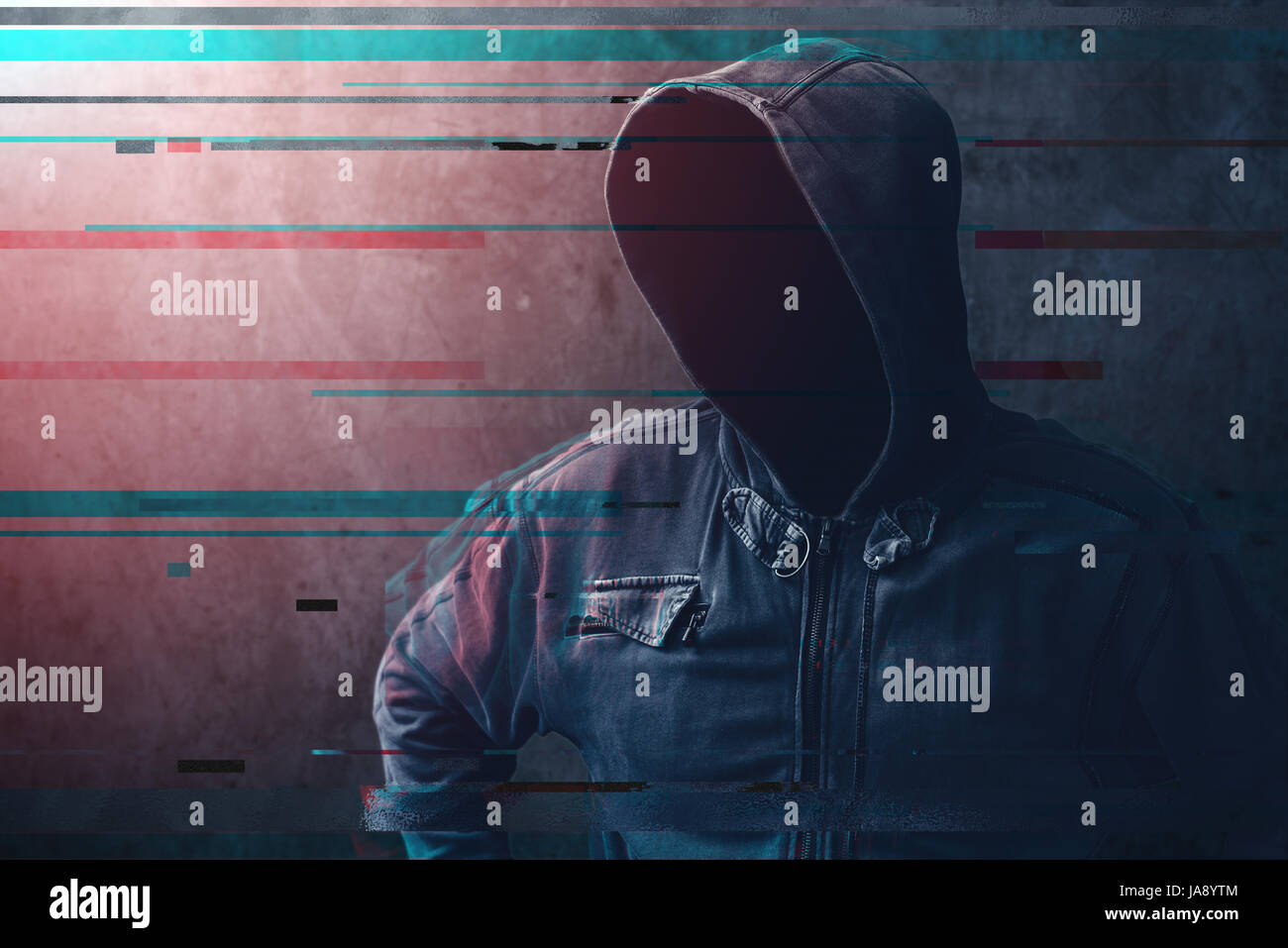 Cyber crime and network security concept, unrecognizable faceless man wearing hooded jacket with digital glitch effect Stock Photo