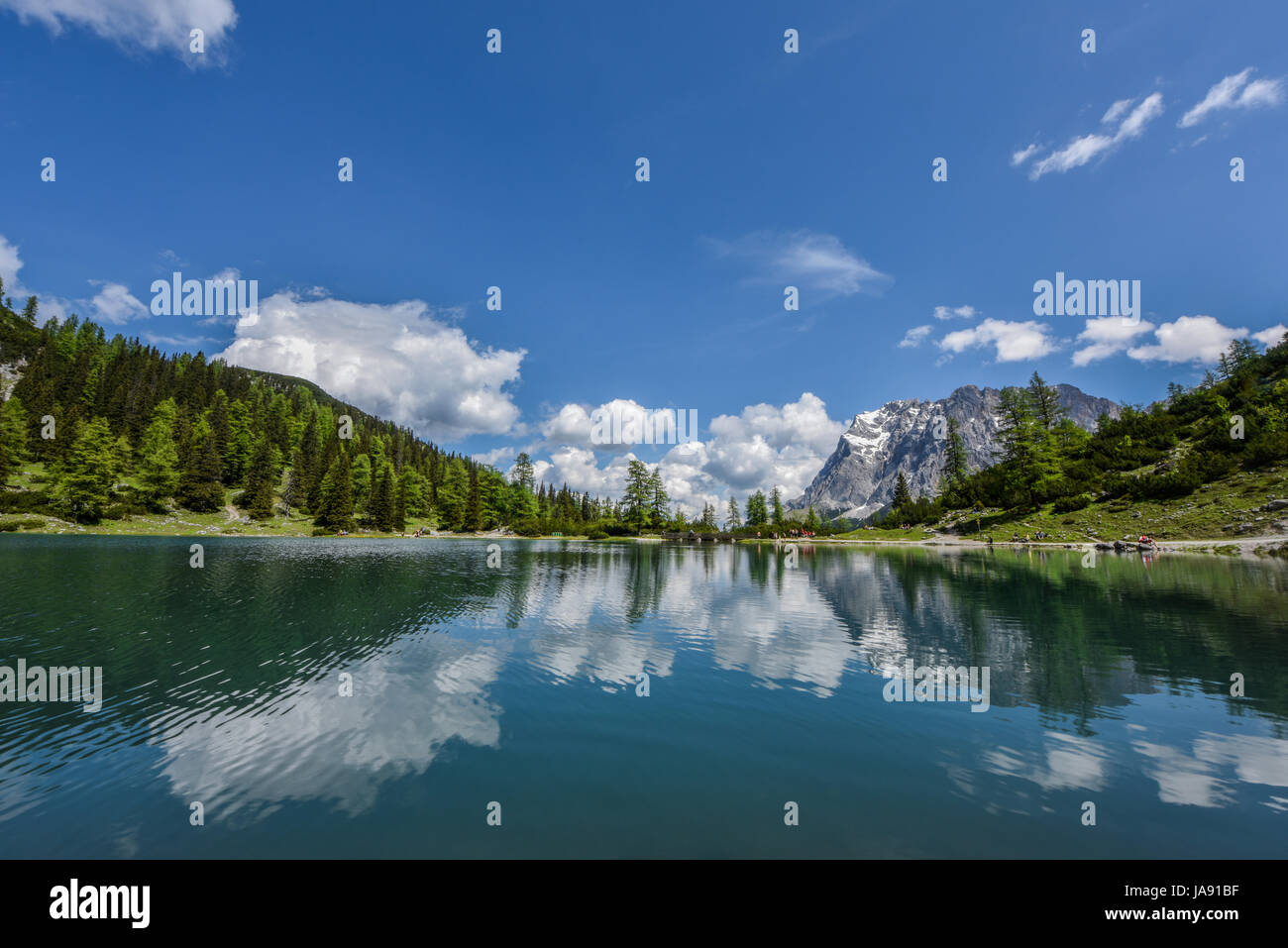 Zugspitze mountain range reflected in the clear turquoise water of lake ...