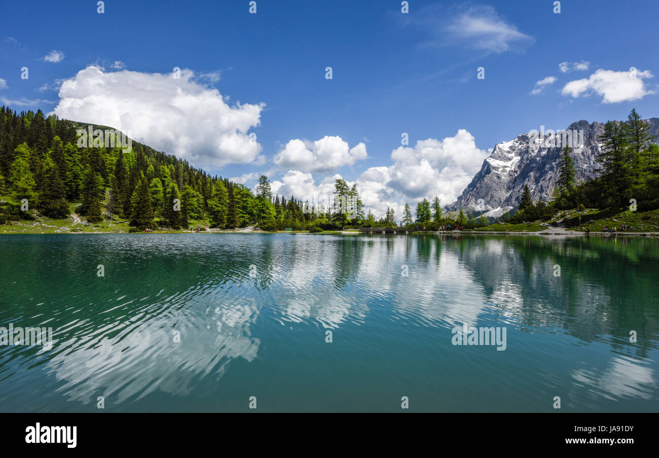 Zugspitze mountain range reflected in the clear turquoise water of lake ...