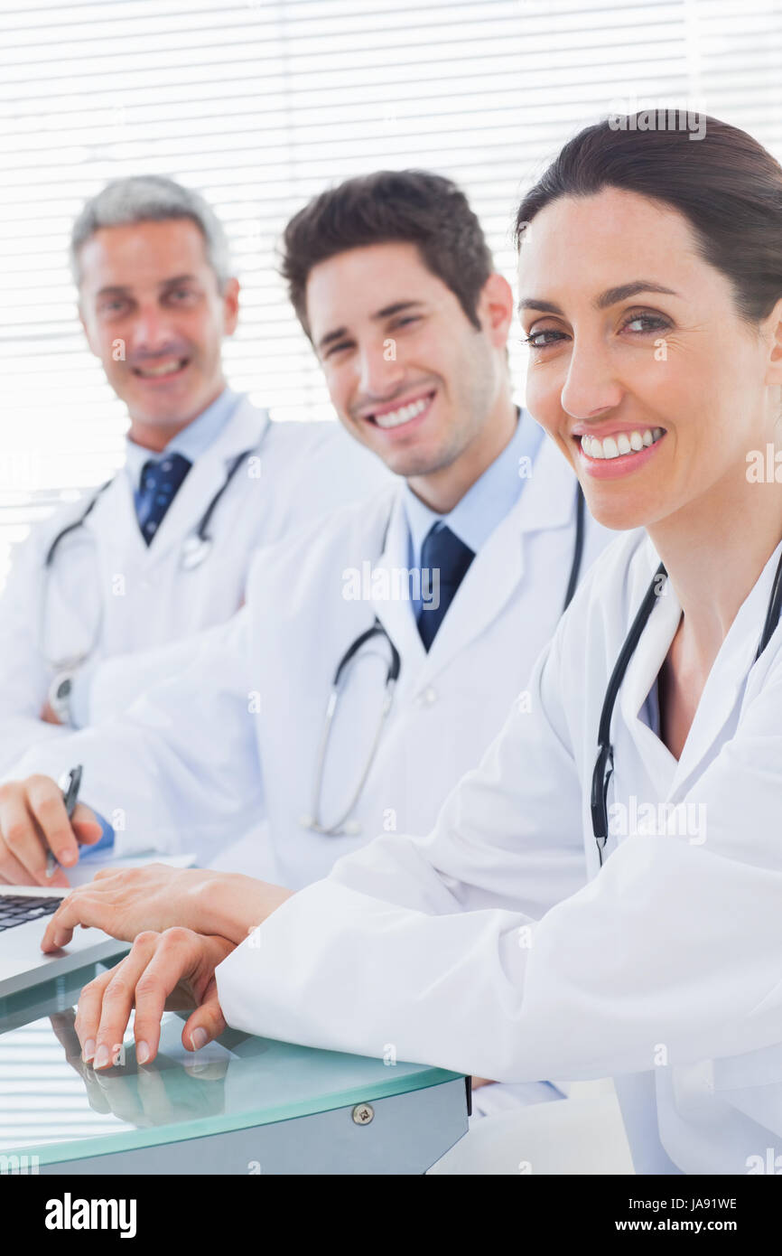 Smiling doctors looking at camera in medical office Stock Photo Alamy