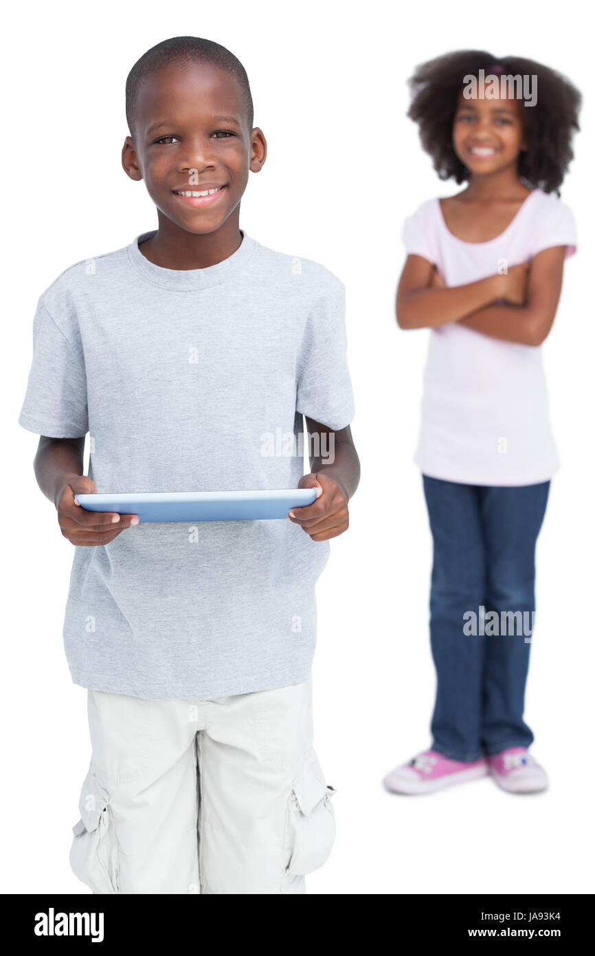 Boy using tablet pc with his sister on a white background Stock Photo ...