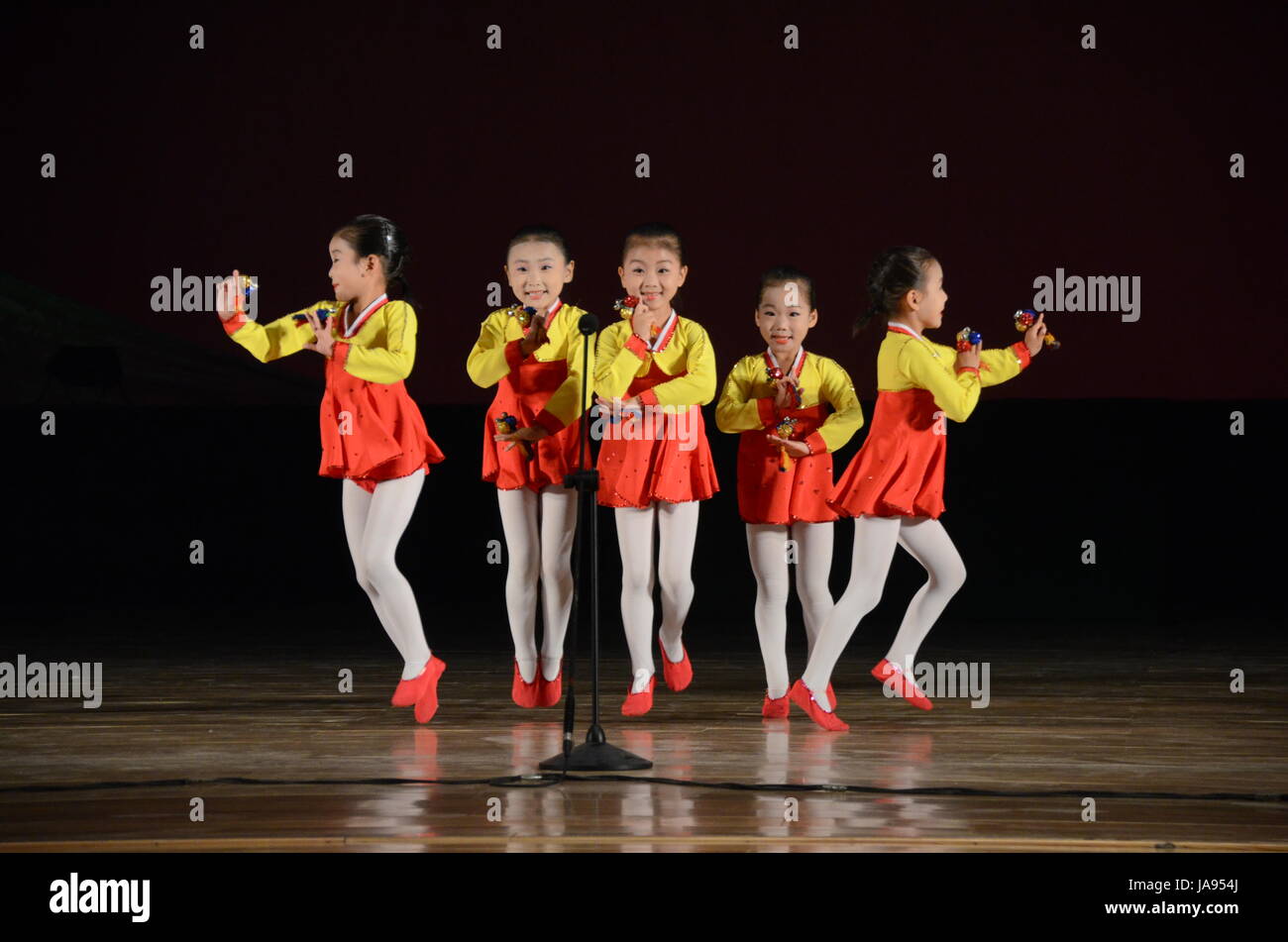 North Korea children performing music and dancing in the city of Rason. Songs hailing the 'Great' and 'Dear Leaders' Kim Il Sung and Kim Jong-Il. Stock Photo