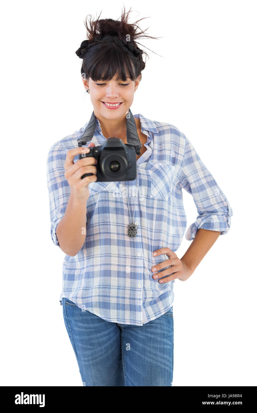 Young woman with hand on her hip taking picture on white background ...