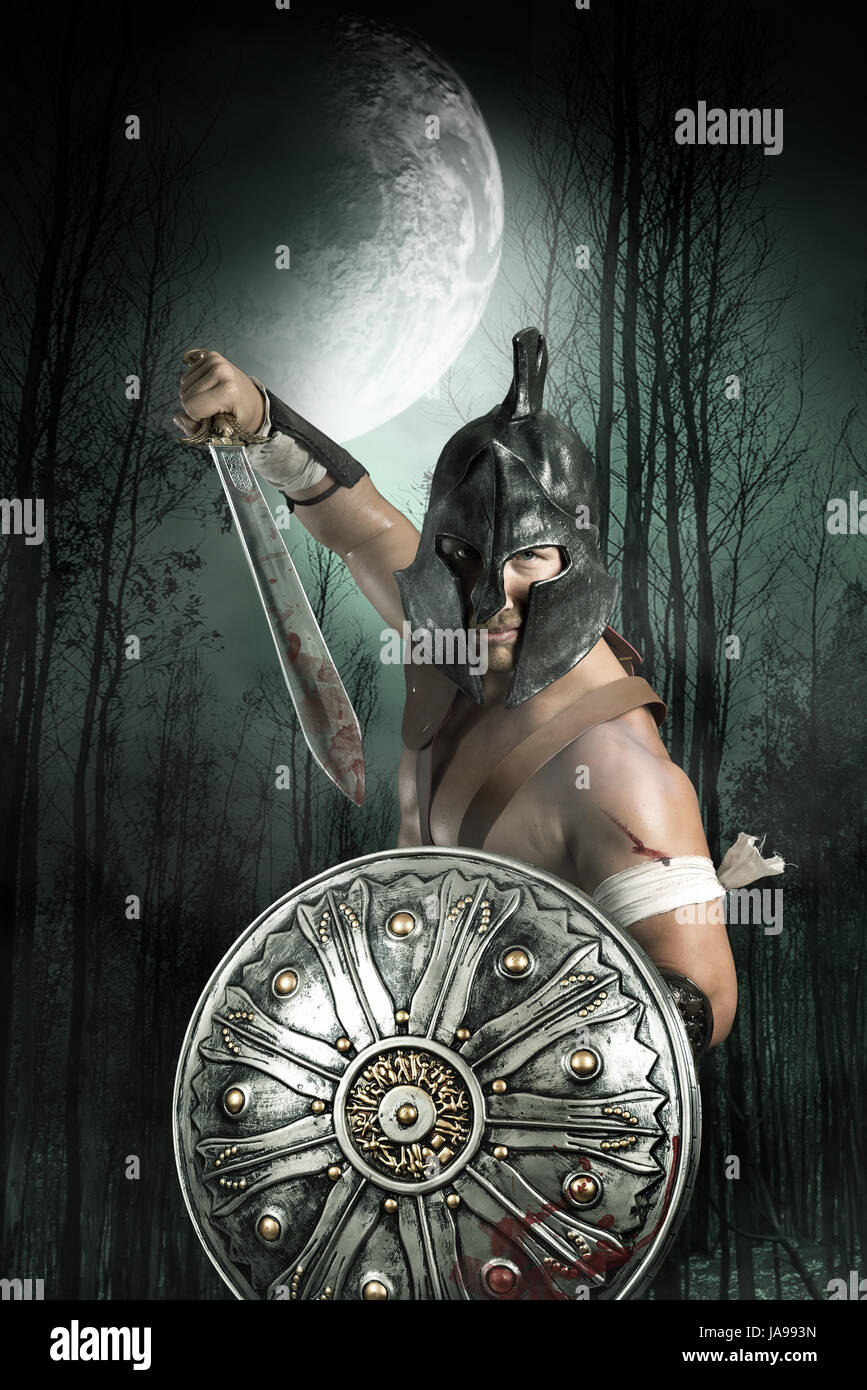 Gladiator with helmet posing ready to fight Stock Photo - Alamy