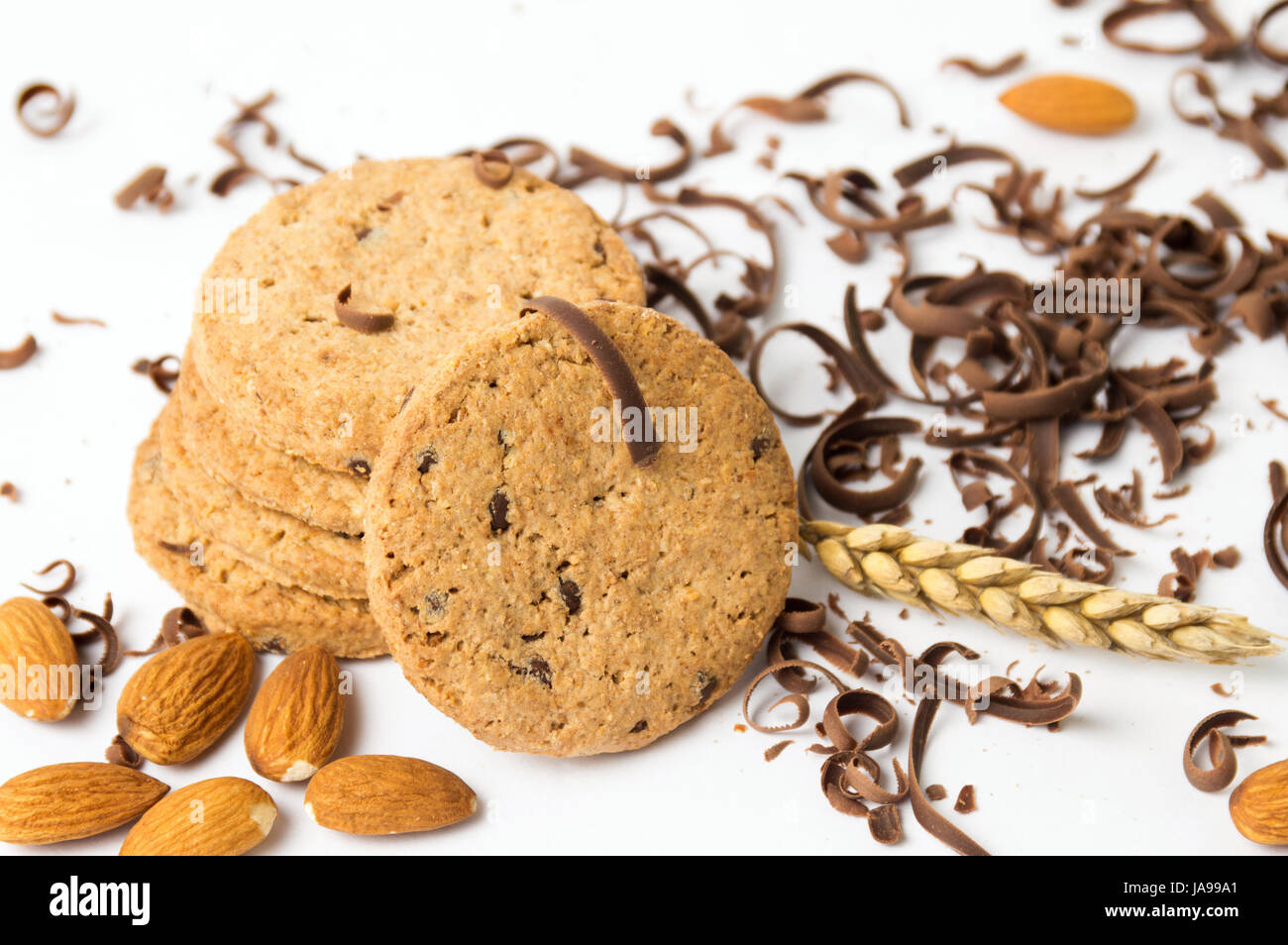 Integral cookies with almonds and chocolate pieces on white Stock Photo