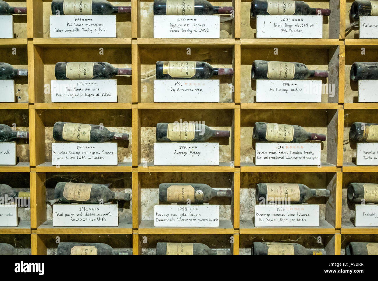 Display of dusty award winning wine bottles, Kanonkop winery, Franschhoek valley, Western Cape, South Africa Stock Photo