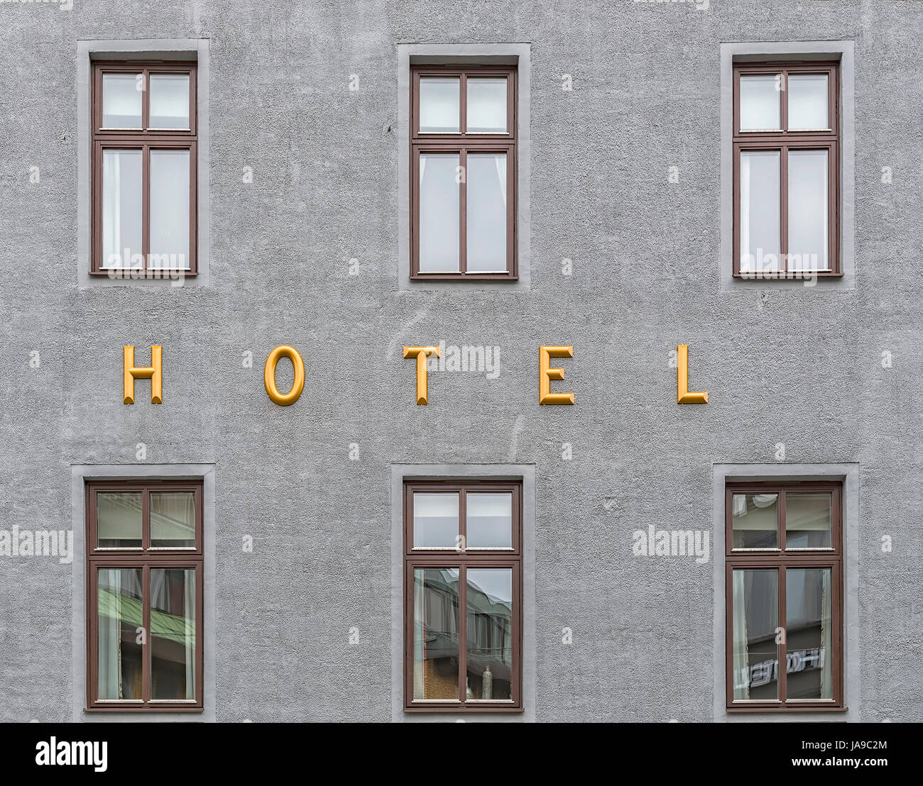 A hotel sign situated next to the room windows Stock Photo