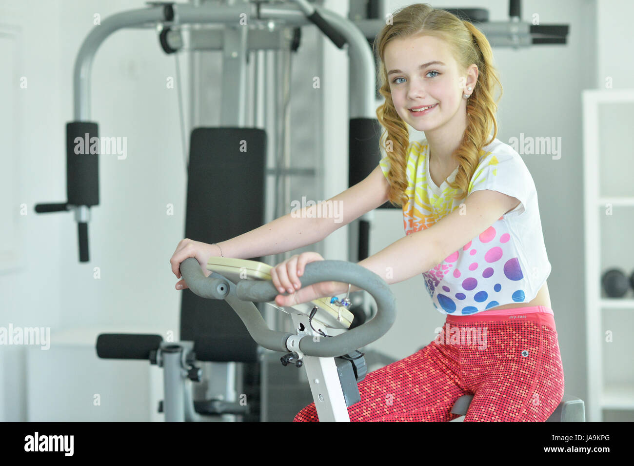 Cute little girl doing exercises Stock Photo - Alamy