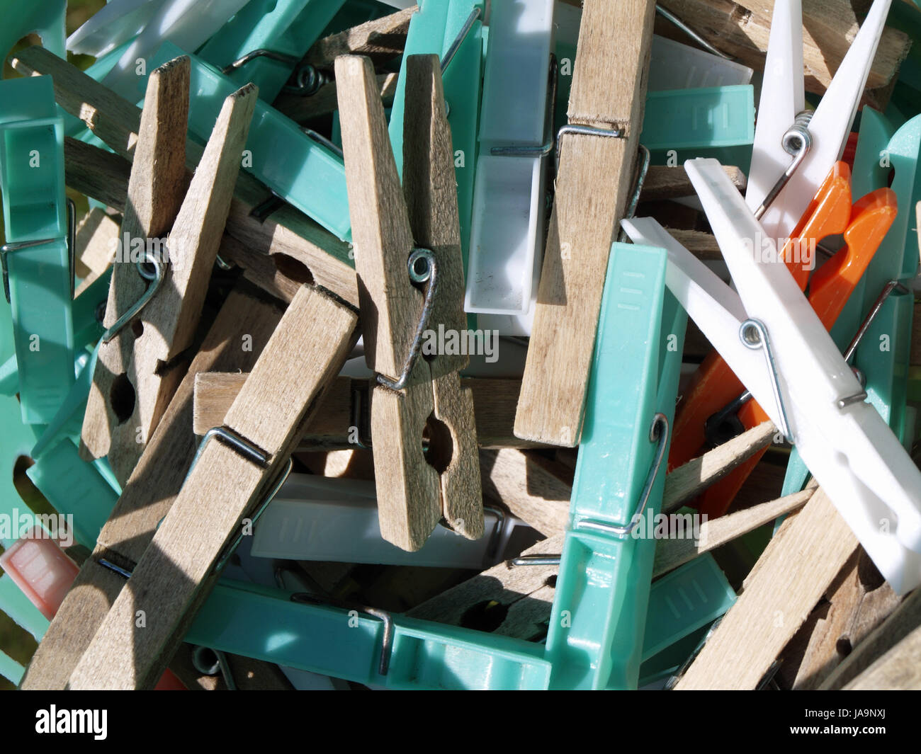Plastic and wooden clothes pegs in basket Stock Photo Alamy