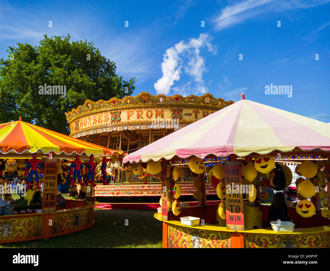 Game stalls and a merry go round at the funfair at the Bath and West Show, Shepton Mallet, Somerset, England. Stock Photo