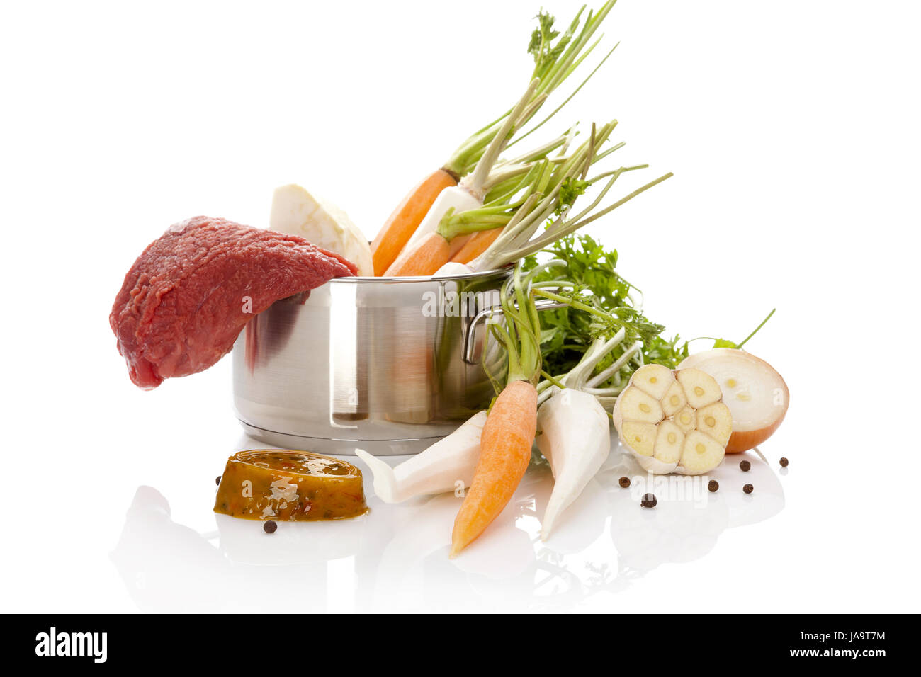 Broth ingredients in silver pot isolated on white background. Bouillon