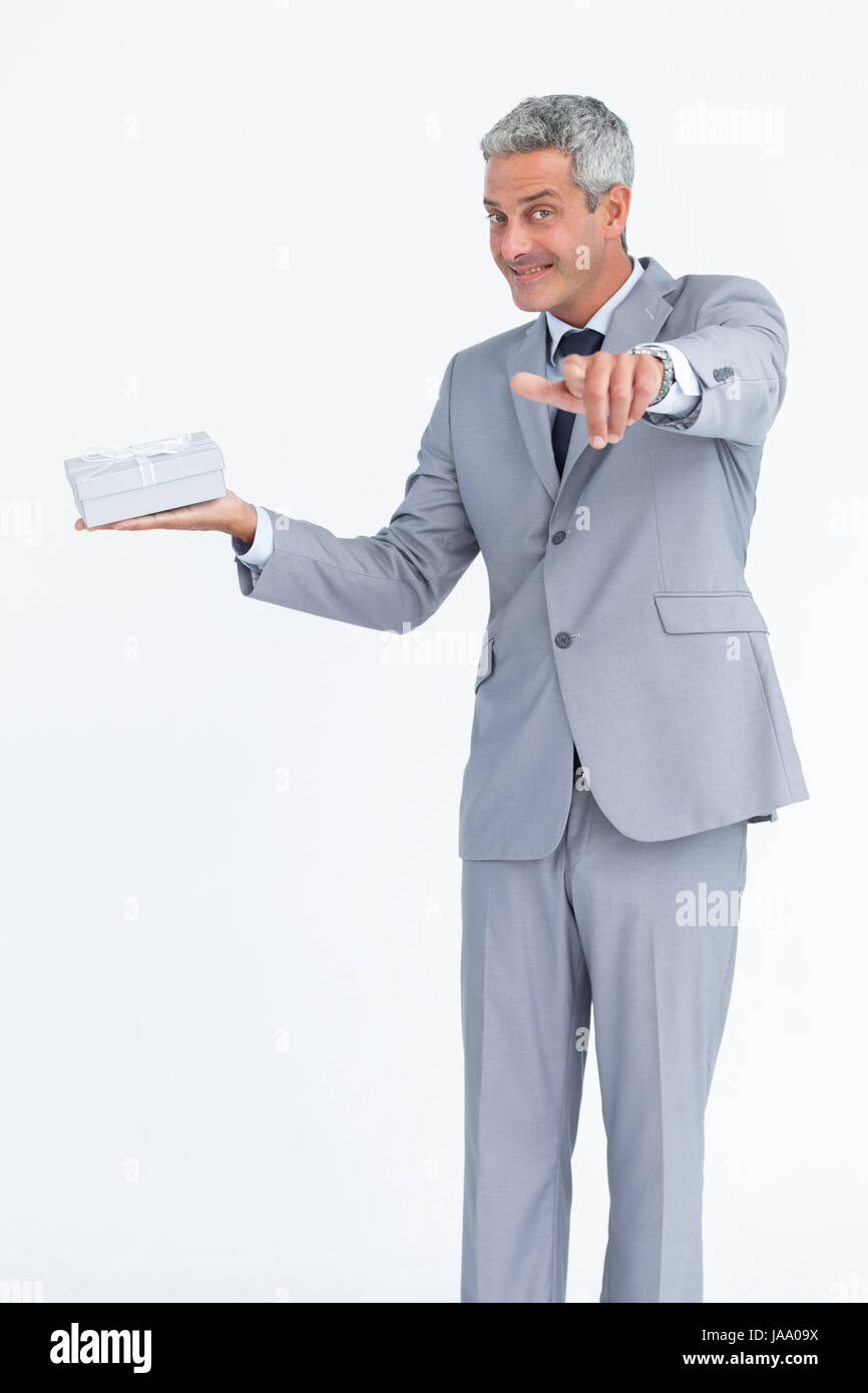 Confident businessman against white background pointing at camera Stock ...