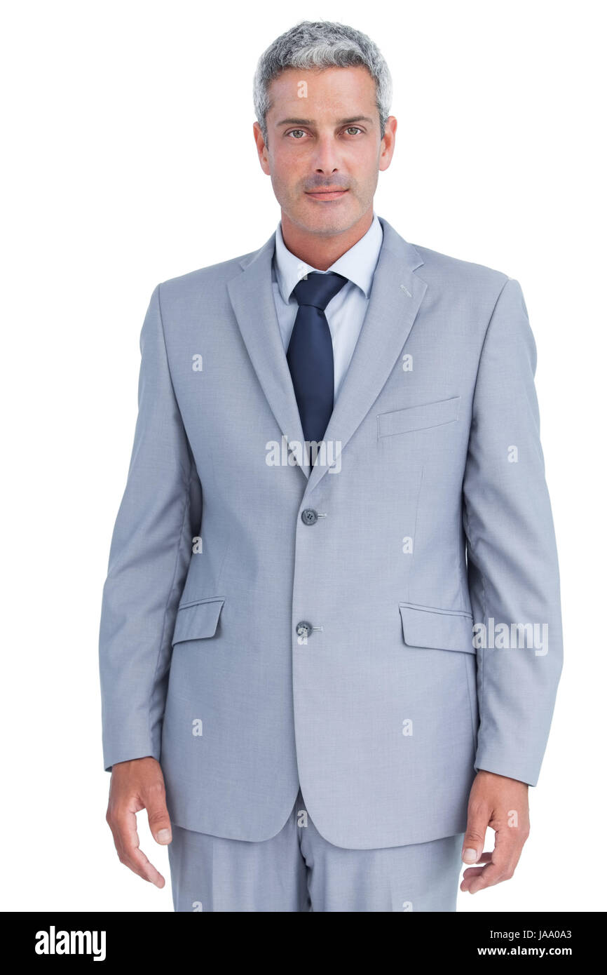 Serious confident businessman posing against white background Stock ...