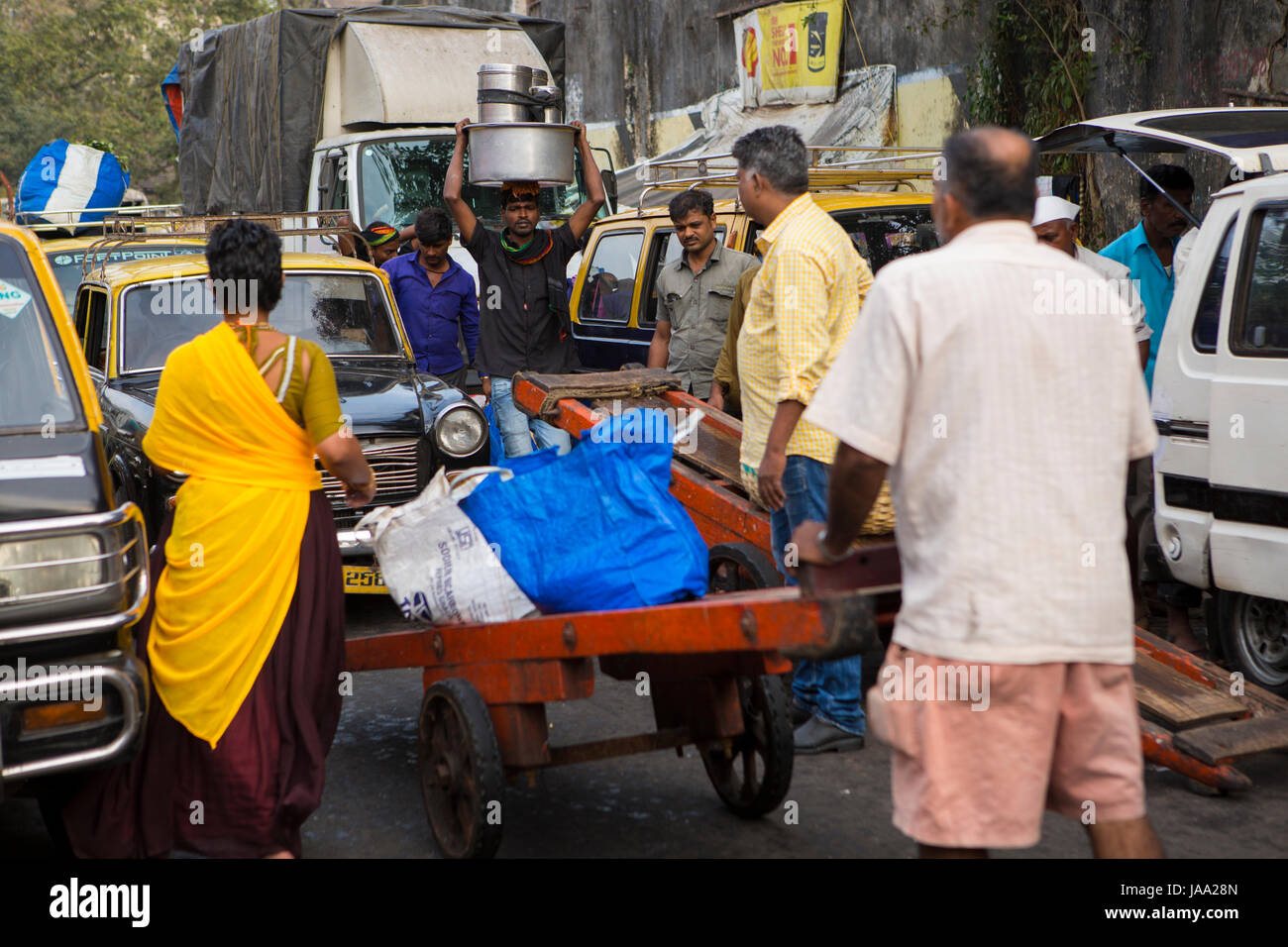 A busy street scene as people arrive and leave the fish market at Sassoon dock, Mumbai, India. Stock Photo