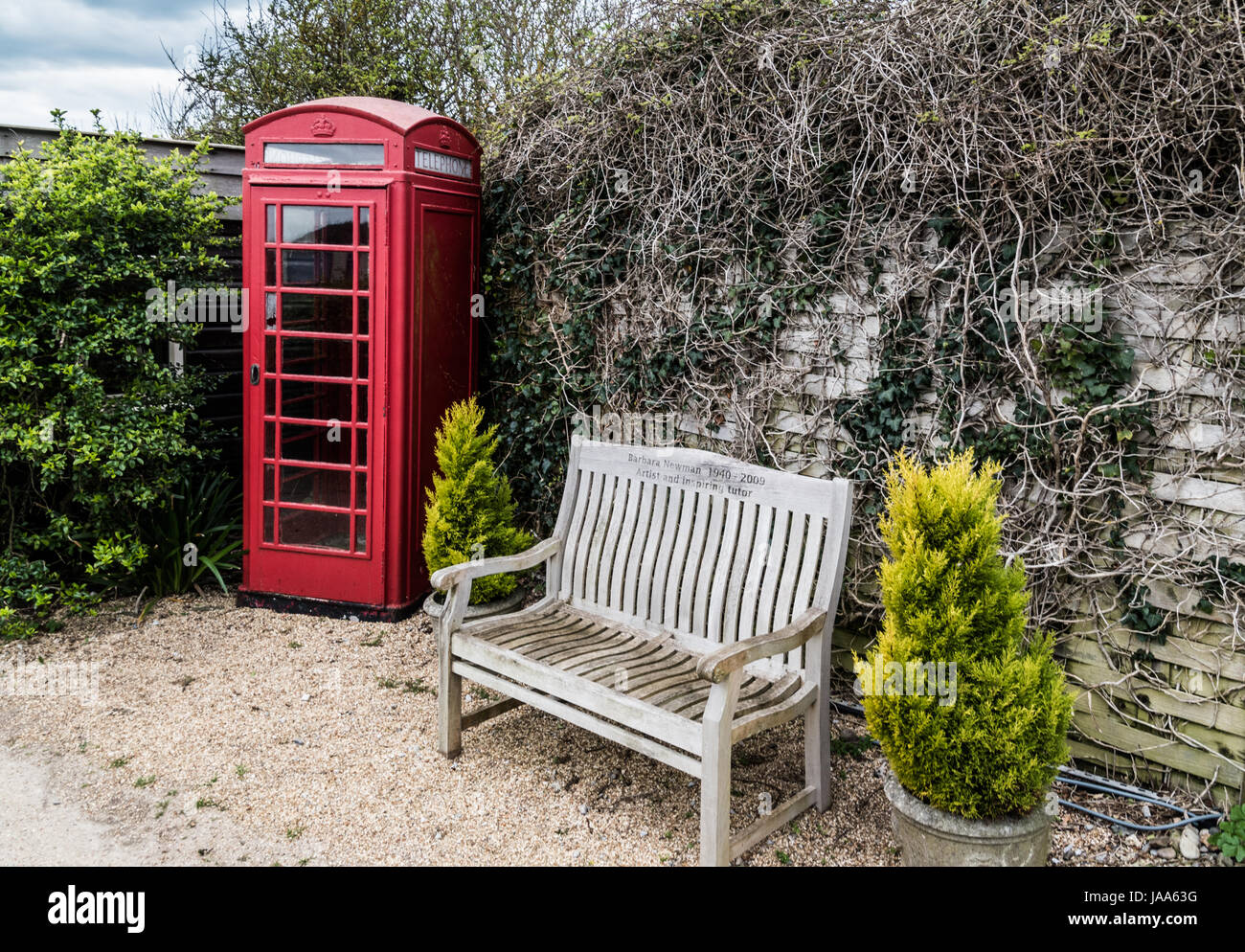 Red phone box and bench seat at Castlehaven Stock Photo