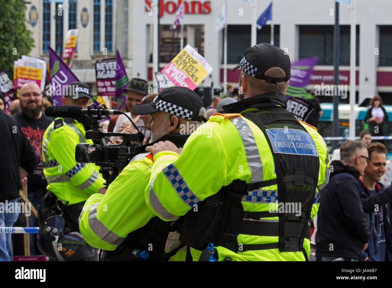 Policeman gathers video evidence during a rally by the far right group English Defence League and a protest by Anti-fascist groups in Liverpool UK Stock Photo