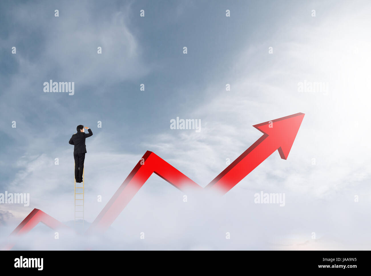 Businessman climbing on a ladder over mountain looking growth chart Stock Photo