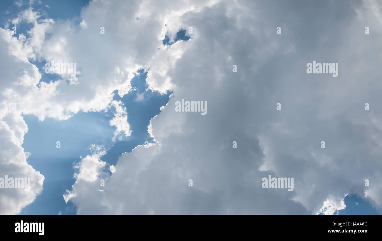 White fluffy clouds on a blue sky background Stock Photo - Alamy