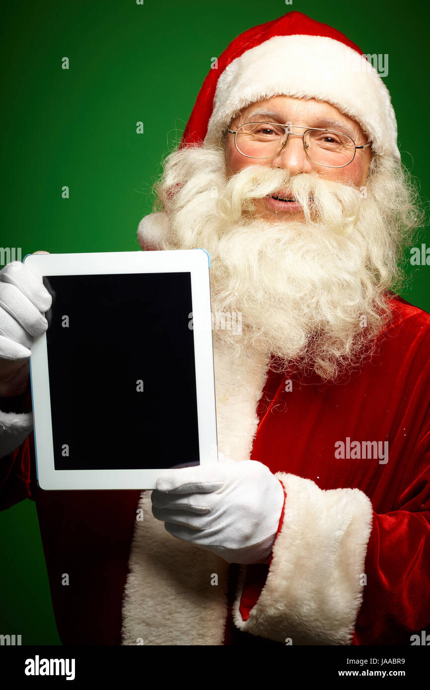 Portrait of happy Santa Claus holding Christmas letter in his hands and ...