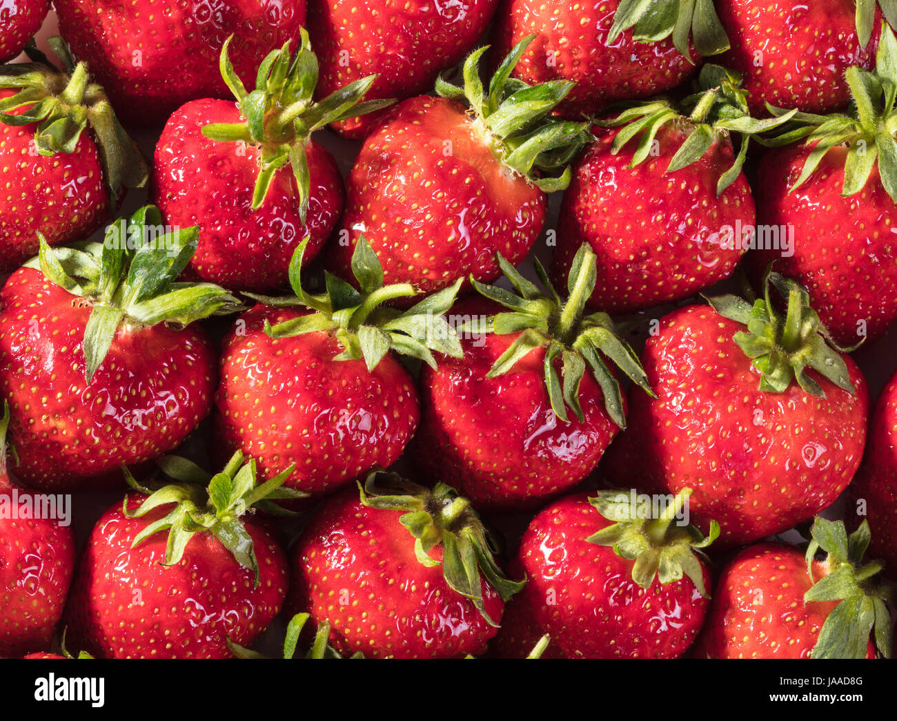 Berry background from a fresh strawberry texture closeup Stock Photo ...