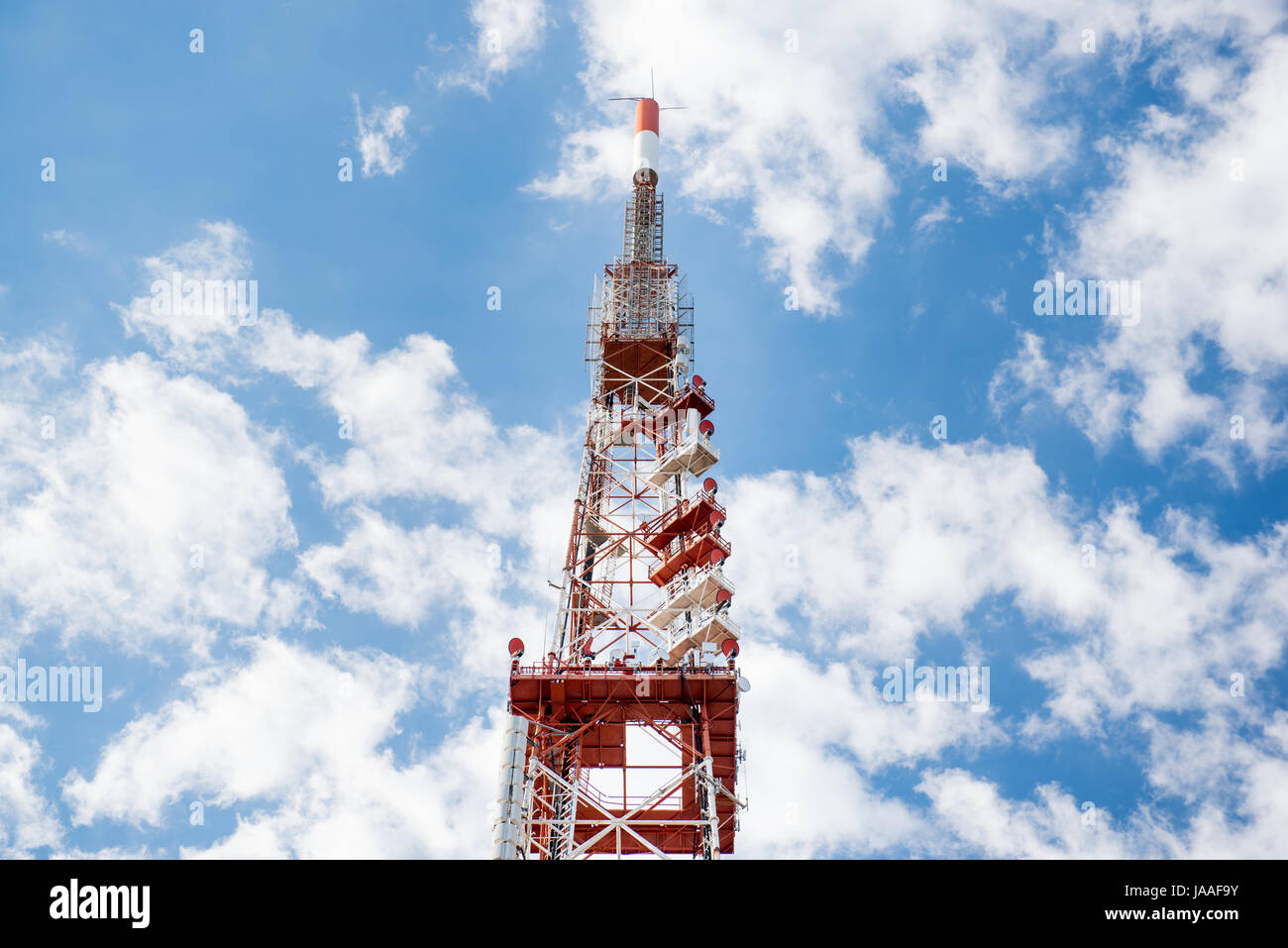 High network telecommunication tower highpoint over blue cloudy sky Stock Photo