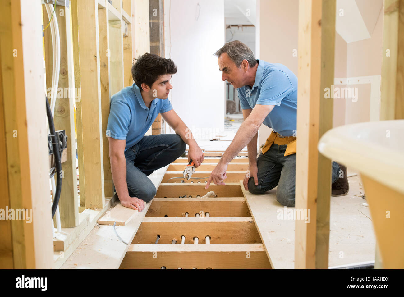 Plumber And Apprentice Fitting Central Heating Stock Photo