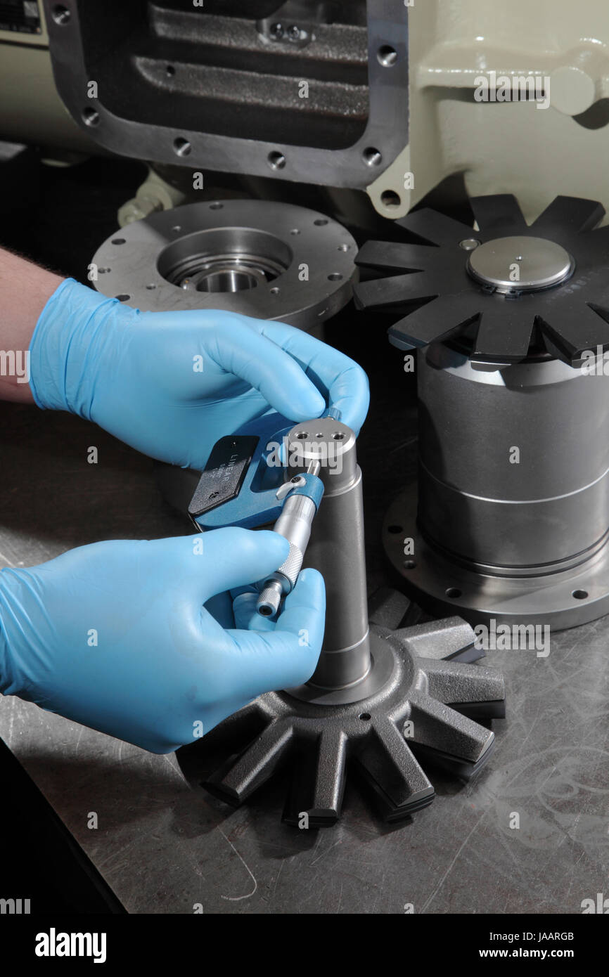 An engineer uses a micrometer to measure the diameter of components